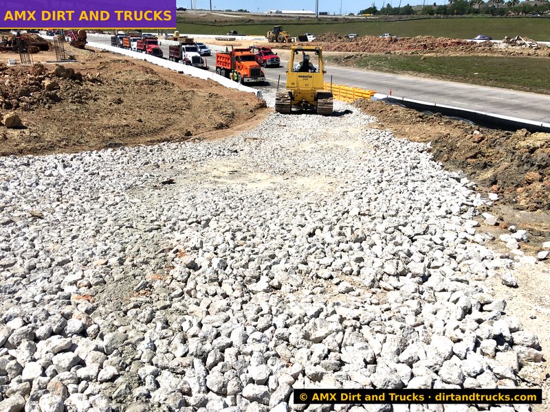 Crushed concrete flex base being spread by bulldozer on TxDOT highway 288 project, Houston