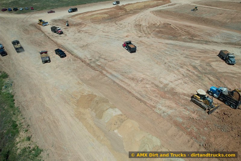 Aerial view of dump truck fleet during land development project near Houston, Texas