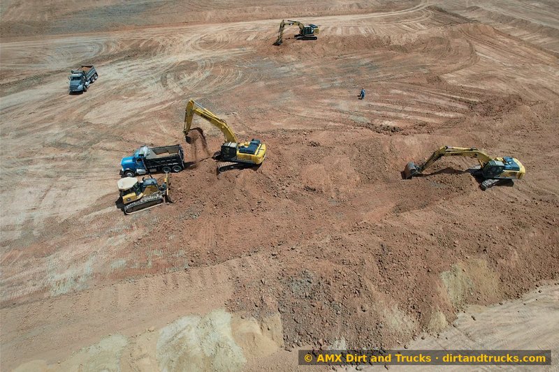 Aerial view of bulldozer and two excavators working a dirt pit operation near Houston